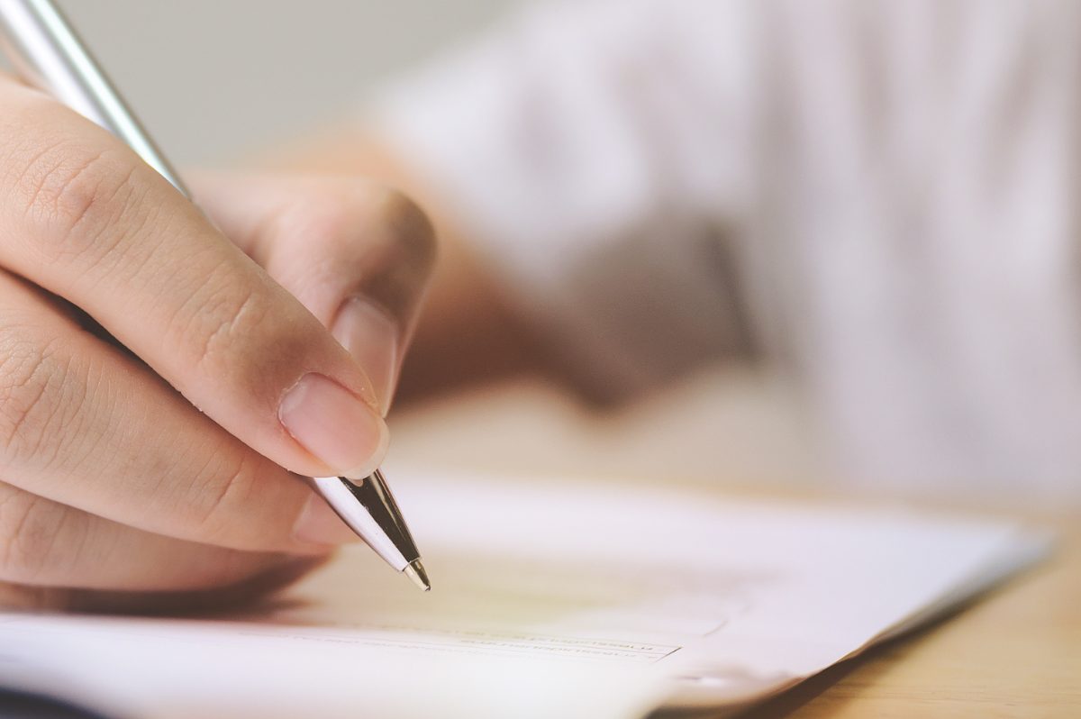 persona rellenando un formulario, cómo designar al beneficiario de un seguro de vida